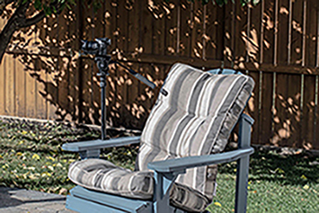 Image of monopod clamped to wooden lawnchair close up