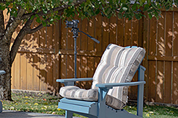 Image of monopod clamped to wooden lawnchair